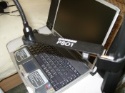 Laptop with pop filter arm above it
